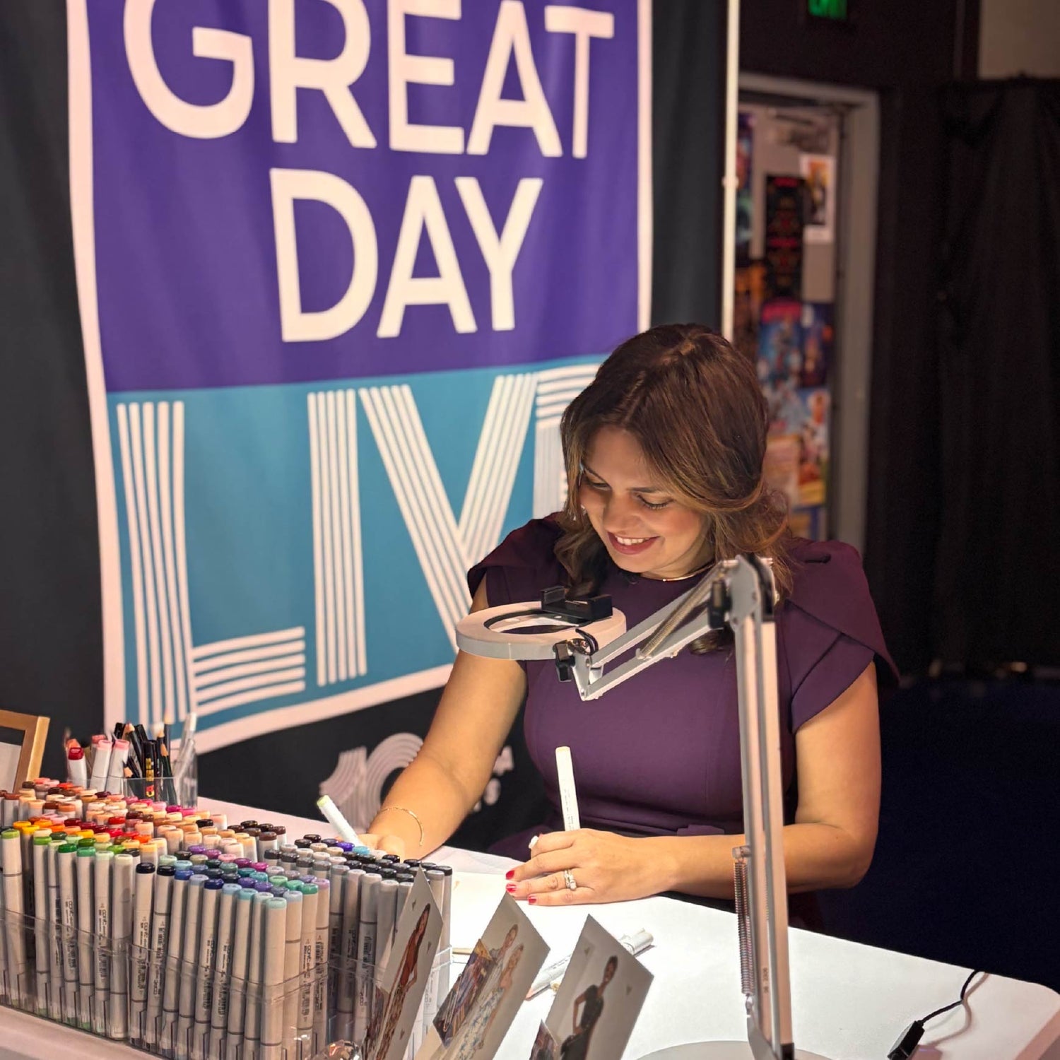 Live sketch artist creating detailed fashion illustrations on set of Great Day Live