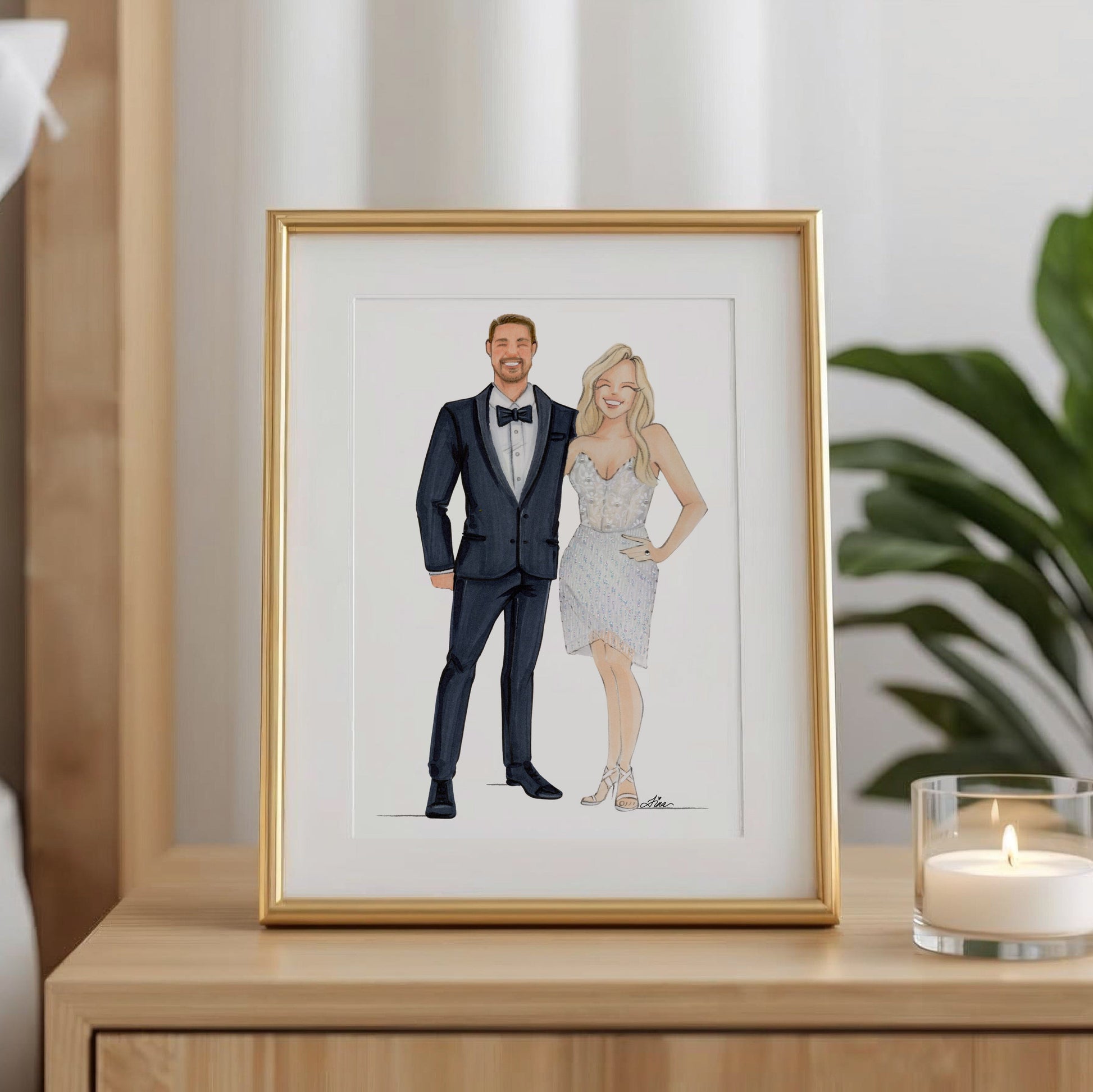 Keepsake Couture framed artwork of a couple on a nightstand with a candle and plant in the background