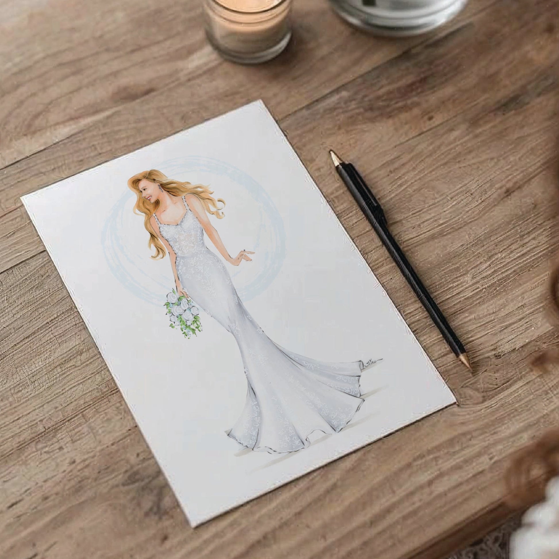 Illustration of a bride on white paper shown on top of a wood table with black pencil
