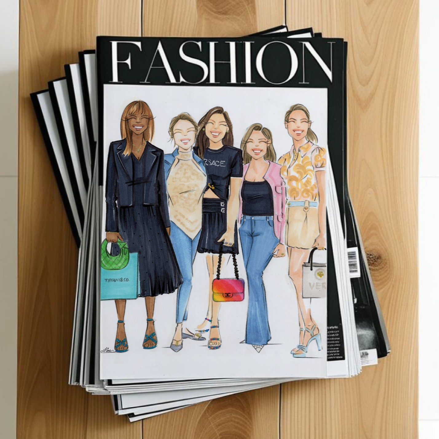 Stack of fashion magazines on a wooden surface with a custom fashion illustration of a group of women laid on top